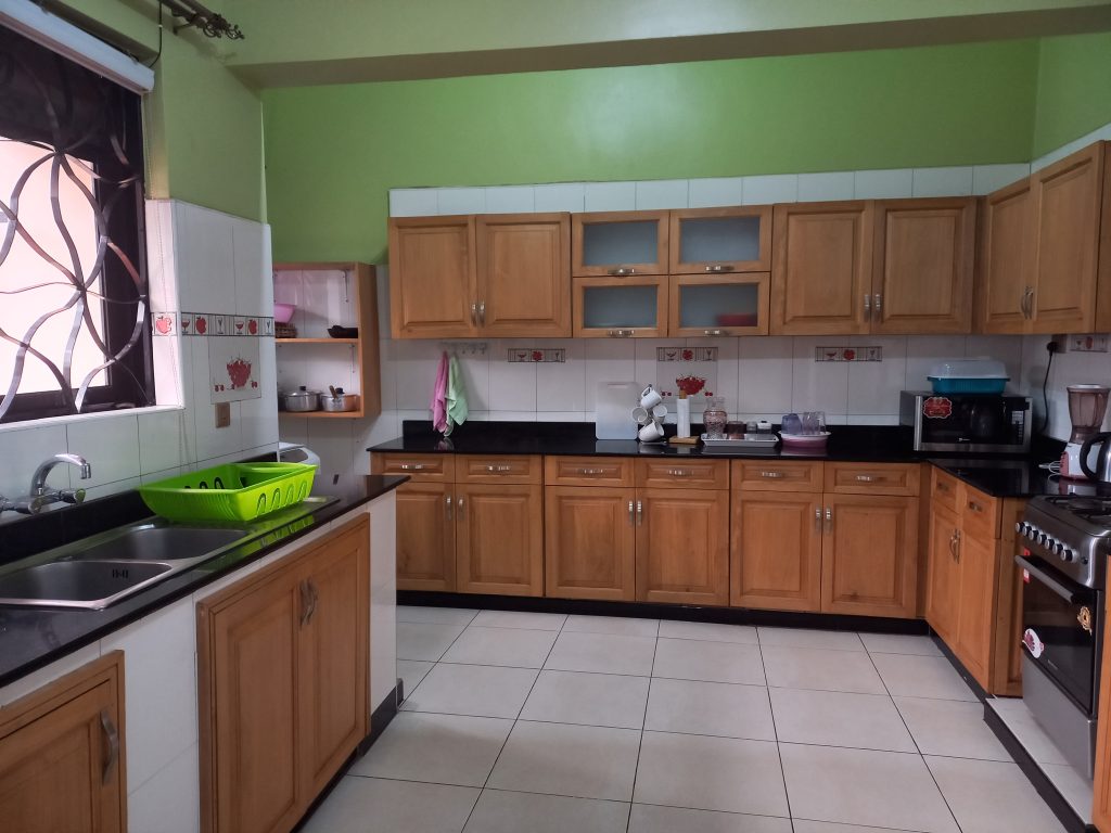 Fully equipped kitchen in Makindye corporate apartment enabling cost-effective business stays
